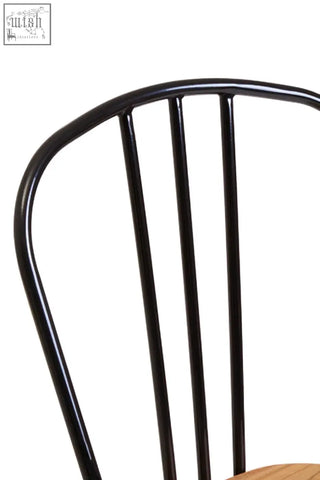 Black metal dining chair with curved top rail vertical spindles and elm wood seat for dining use