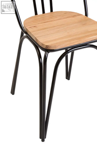 Black metal frame dining chair with light brown elm wood seat perfect for dining room use