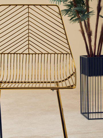 District gold metal tapered bar chair in gold metal wire with a geometric chevron pattern and slender legs