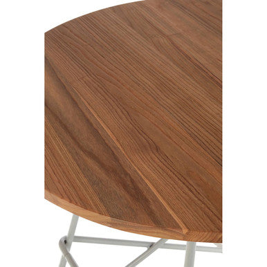The district grey metal and elm wood round dining table features a warm brown wooden top with sleek metal legs
