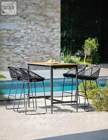 Black woven mesh bar stools with black cushions around a wooden dmitry outdoor garden table on a patio