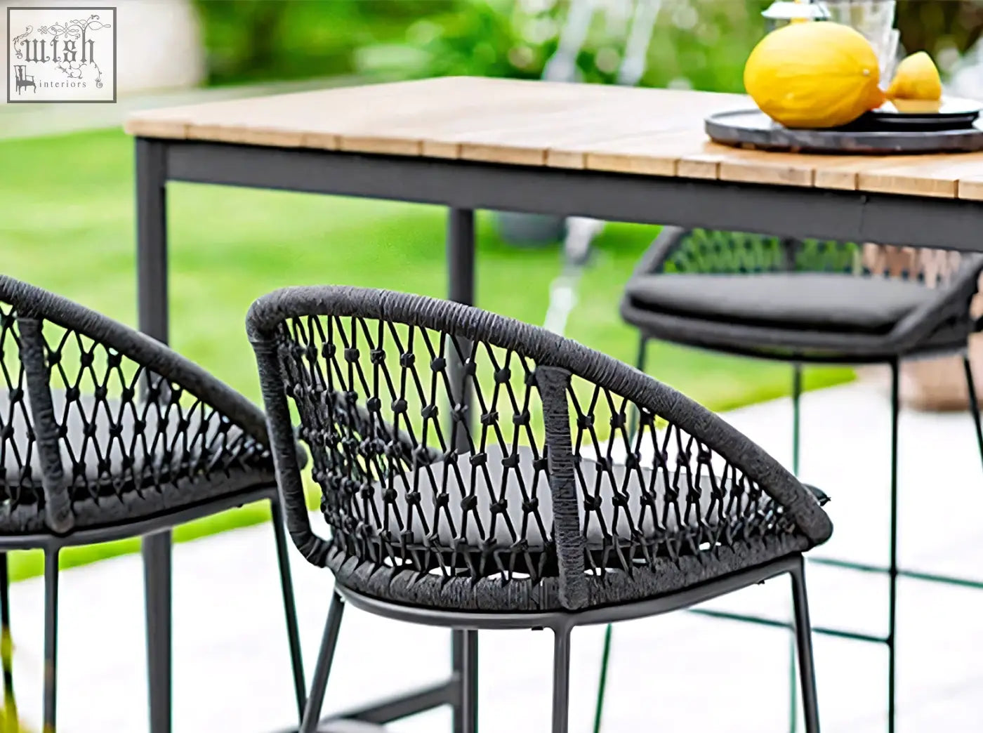 Black woven wicker bar stool with cushioned seat and metal frame from dmitry outdoor garden table set