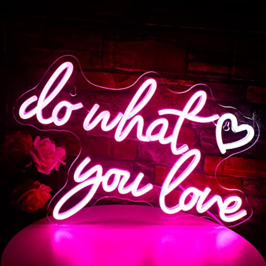 A glowing pink love neon sign made from illuminated tubing for wall decor with usb powered led light