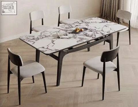 Dobson dining table features a sintered stone white marble top with gray veining and dark wood legs for a contemporary dining room