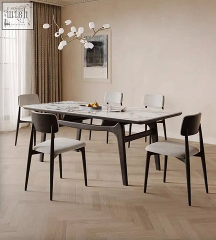Dobson dining table with sleek sintered stone marble top and dark wood legs in a contemporary dining room setting