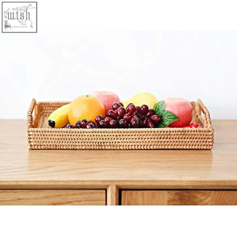 Dokot rectangular rattan serving tray with handles holding colorful fresh fruit for coffee table and home decor use