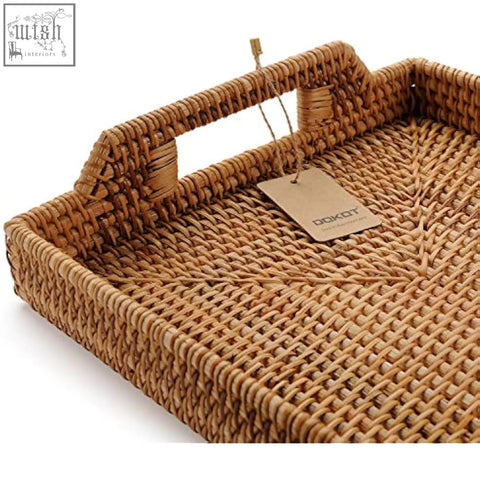 A natural brown rattan rectangle serving tray with handles and a dokot tag ideal for coffee table use