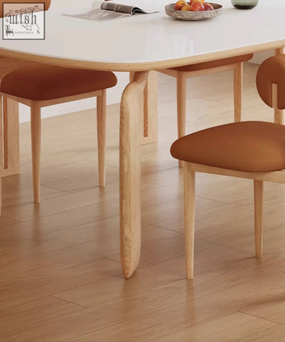 Light wood domingo dining table with curved legs and smooth white sintered stone surface for dining