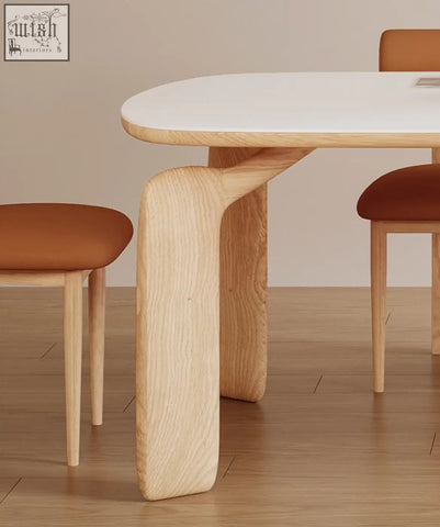 A sleek domingo dining table with a smooth white sintered stone top and sculpted light oak legs for modern dining areas