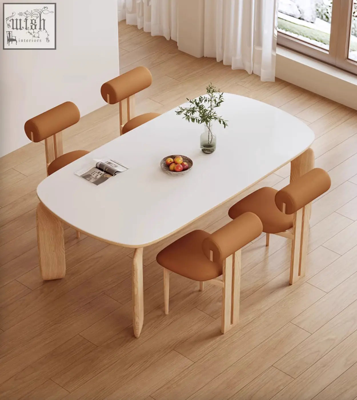 White oval domingo dining table with sintered stone top and light wood legs paired with tan upholstered chairs