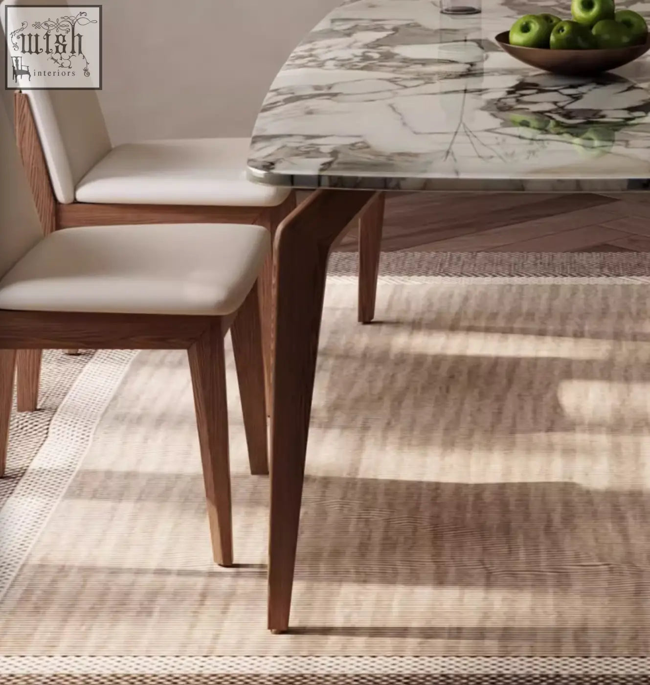 Dominic dining table featuring an oval marble top with wooden legs paired with beige padded dining chairs