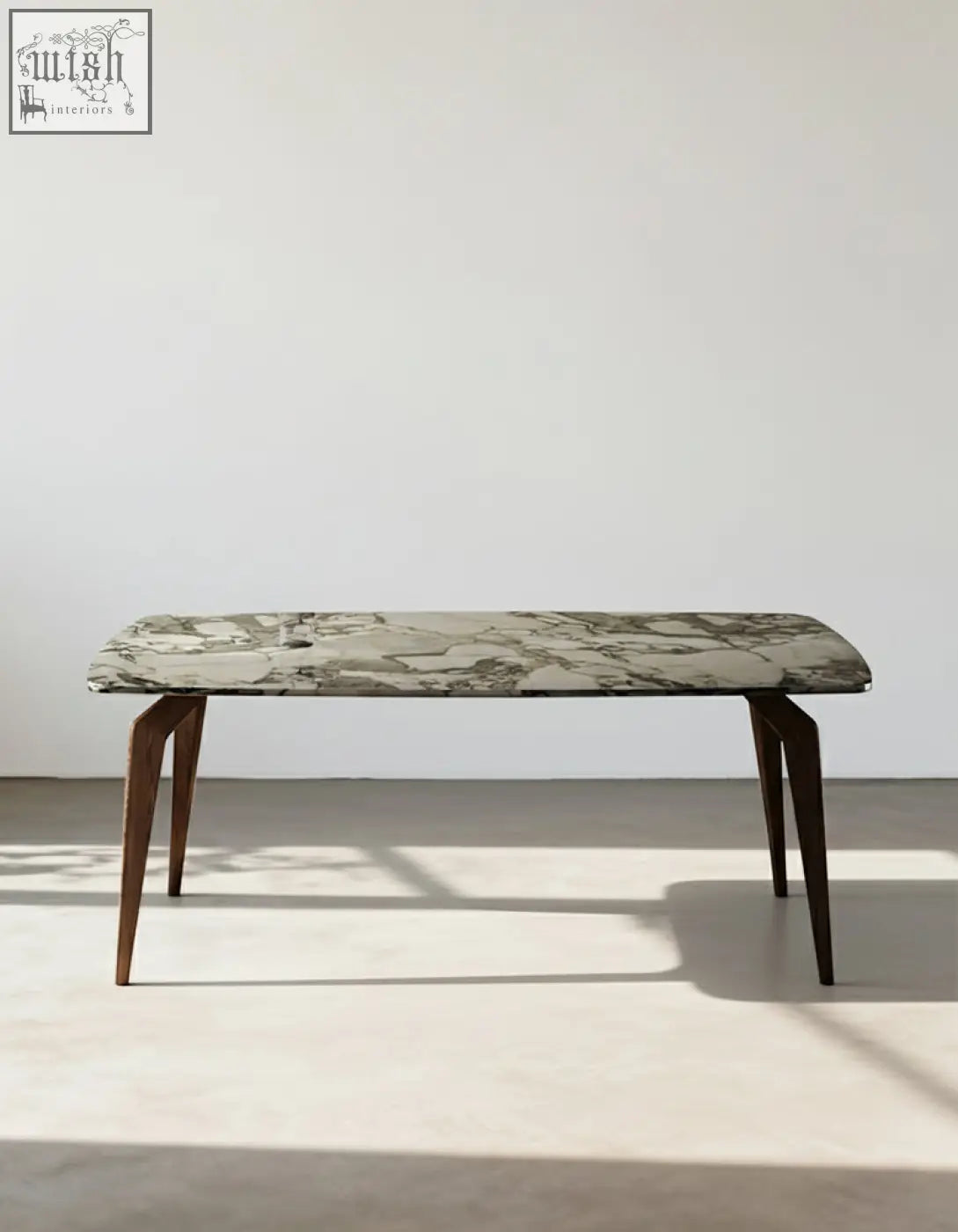 A sleek dominic dining table with a polished green and white marble top and dark wood legs perfect for dining areas