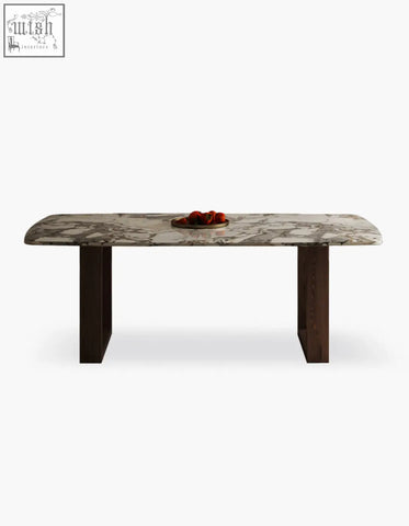 A sleek donovan dining table with a polished white and gray marble top and dark wood legs perfect for dining room use