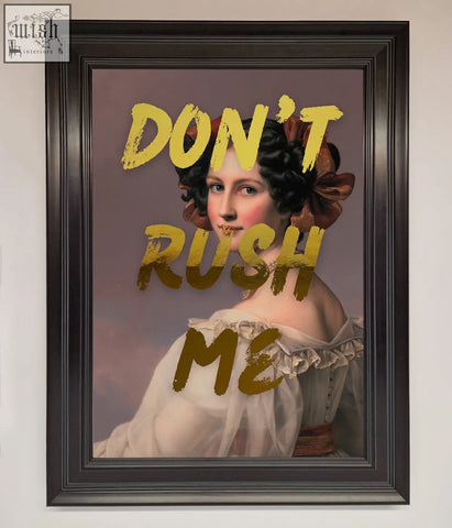 A framed dont rush me foil print featuring a woman in a white gown with gold lettering perfect for shipping time decor