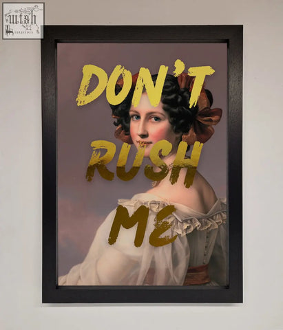 A framed dont rush me foil print portrait of a woman in an off-white ruffled gown with dark hair and a brown bow