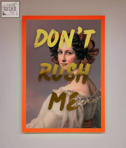 Framed dont rush foil print featuring a classical woman portrait with dark hair and bold yellow text in an orange border