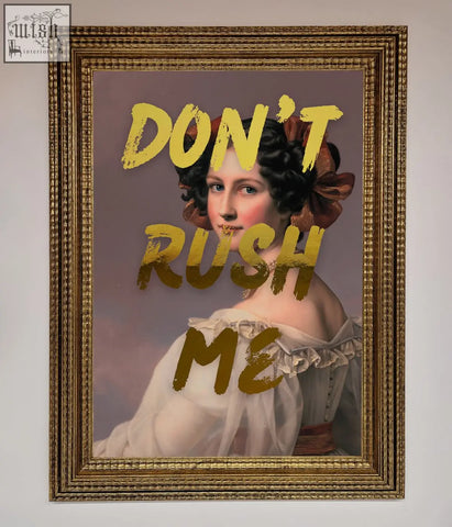 A gold-framed foil print titled dont rush me featuring a woman in a white gown with bold yellow lettering about shipping times
