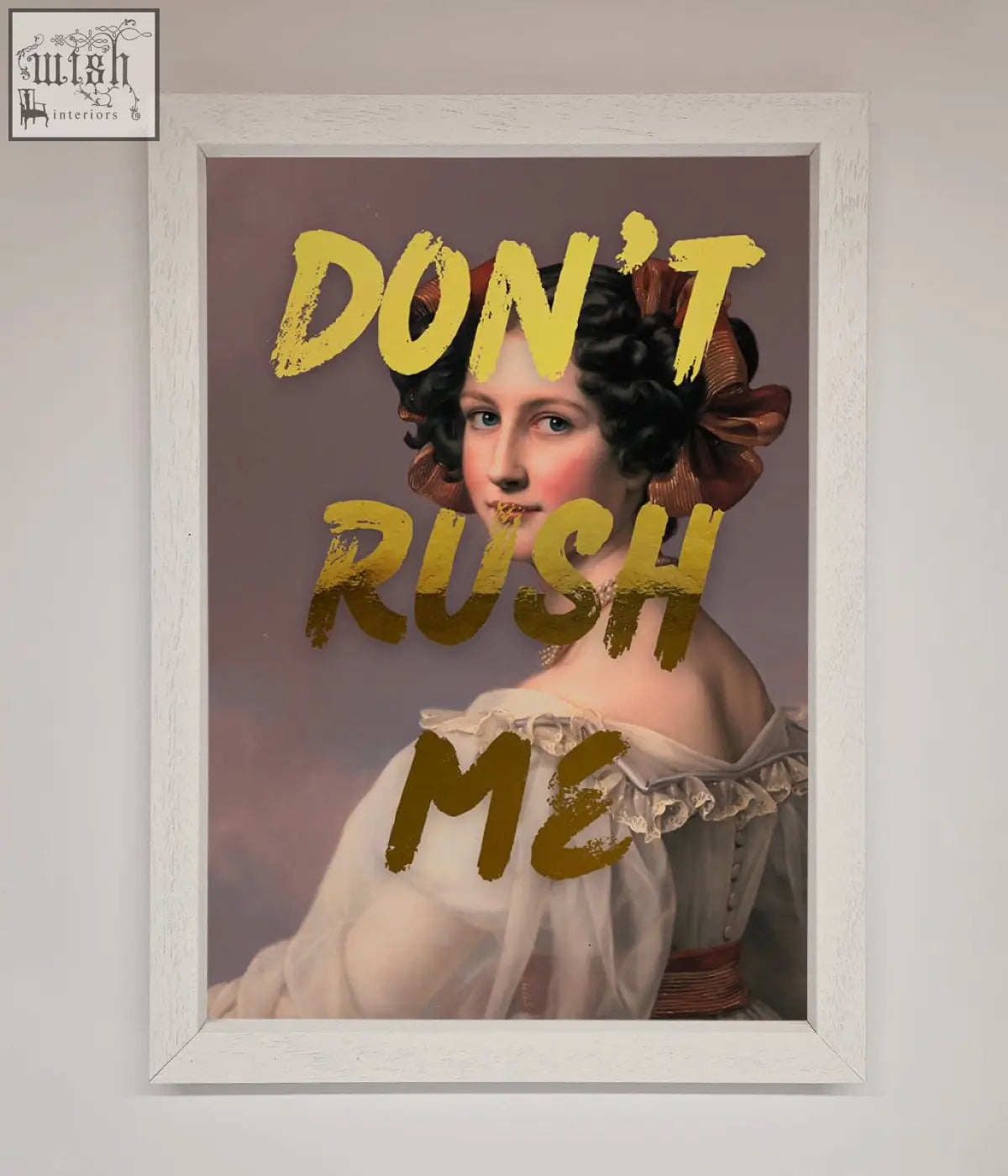 A framed dont rush me foil print featuring a woman in a white off the shoulder gown with bold yellow text about shipping time