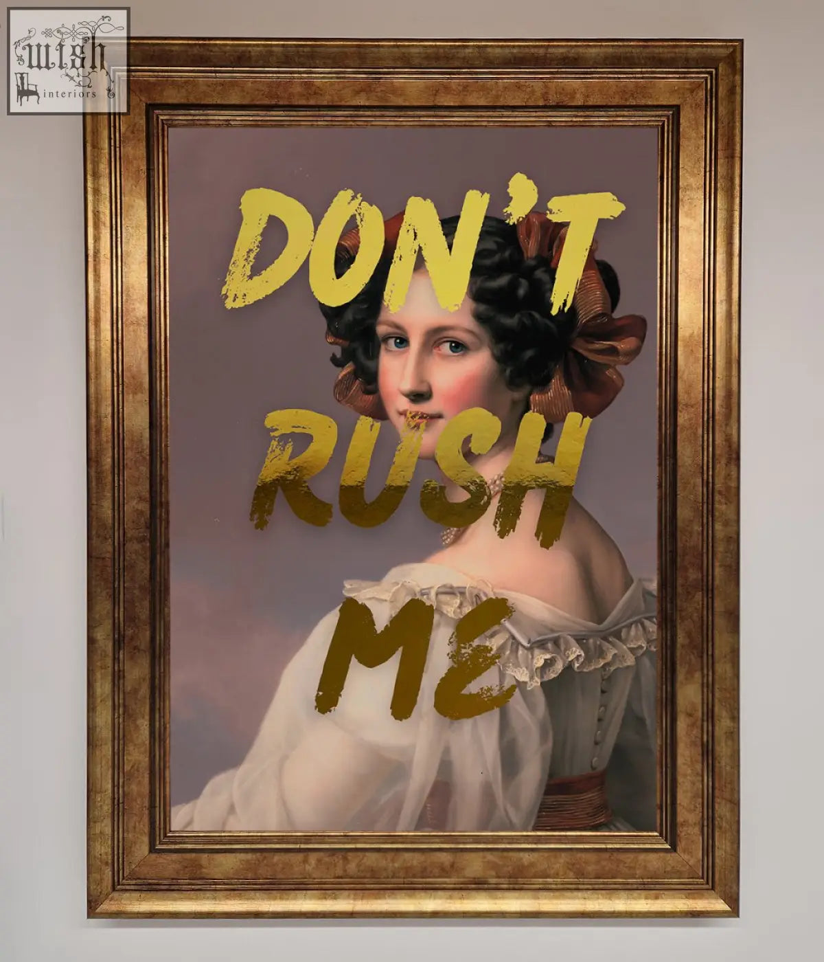 A gold-framed dont rush foil print featuring a woman in a white gown with dark hair, perfect for shipping time decor