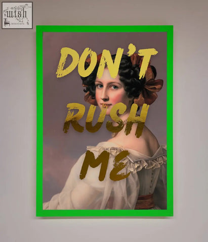 A dont rush foil print featuring a classical woman in an off-white gown with bold gold lettering in a green frame