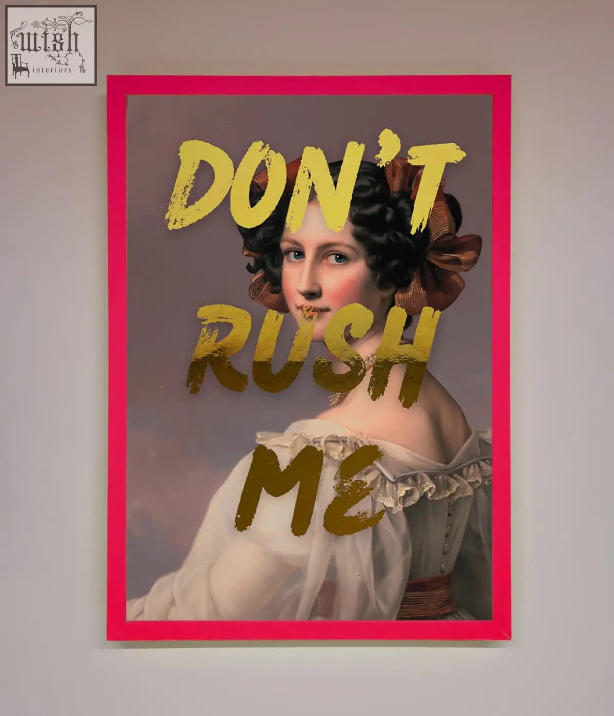 A vibrant pink-framed dont rush foil print showing a classical woman portrait with gold foil lettering about shipping times