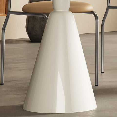 A sleek glossy white conical table base of the doreen dining table with a smooth modern design
