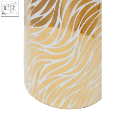 Gold-colored doria large white ceramic jar with a flowing white wave pattern etched on its surface
