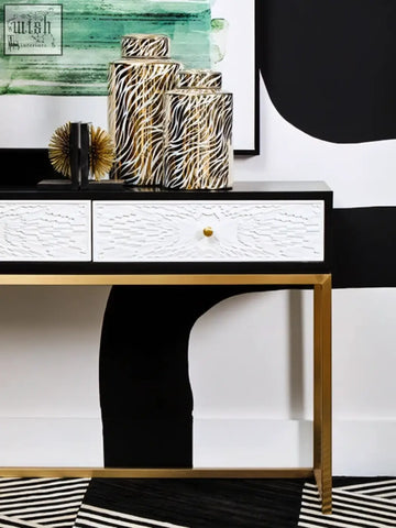 Zebra-printed glossy cylindrical storage boxes styled with doria large white and gold finish ceramic jar design