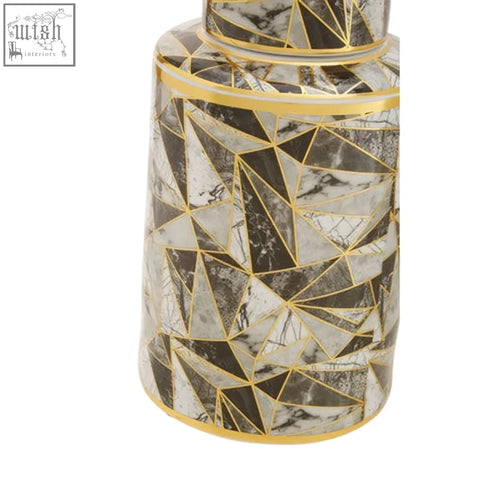 A sleek ceramic jar with a black and white marble effect pattern and gold geometric outlines called doria small jar