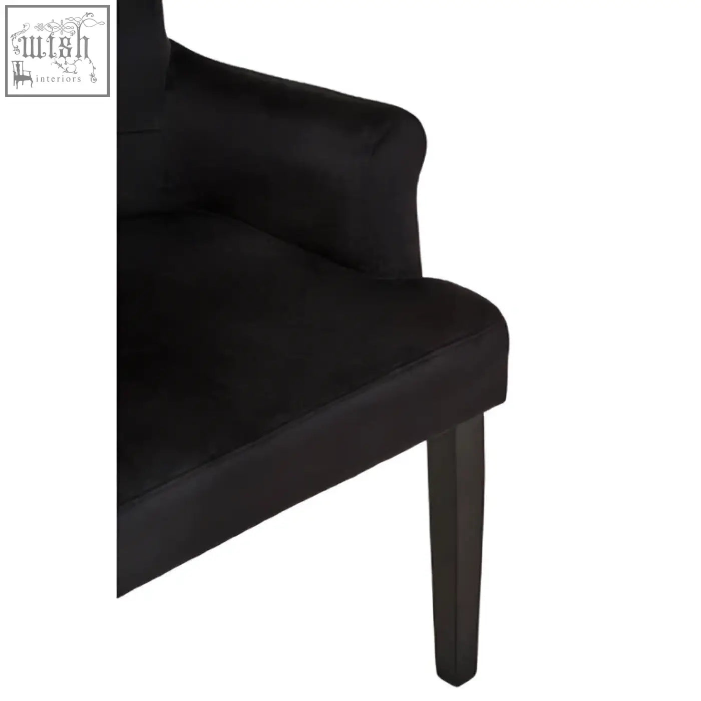 Doucet black velvet dining chair with ring back and dark wooden legs in a sleek black velvet finish