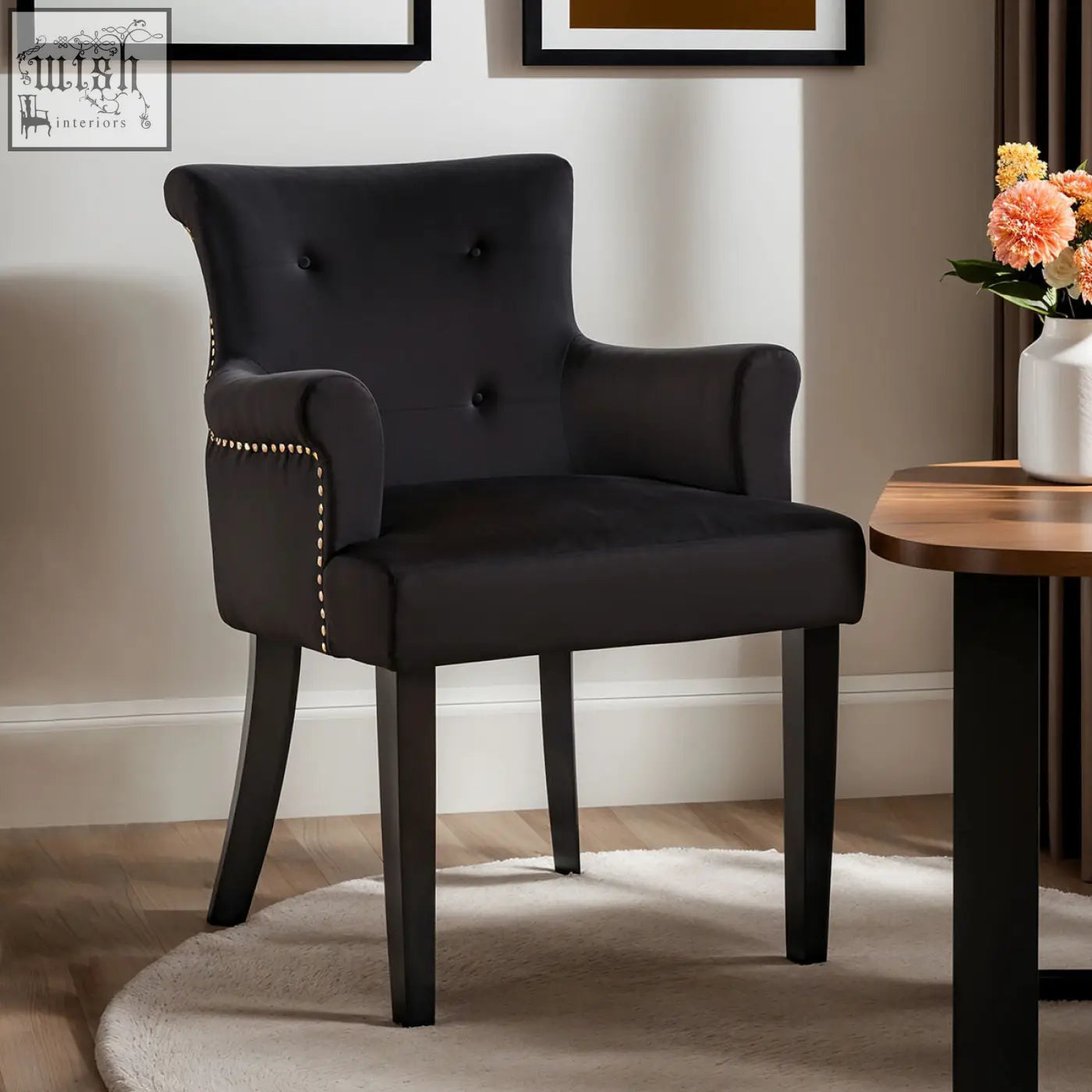 Black velvet dining chair with tufted back and gold nailhead trim perfect for stylish dining rooms
