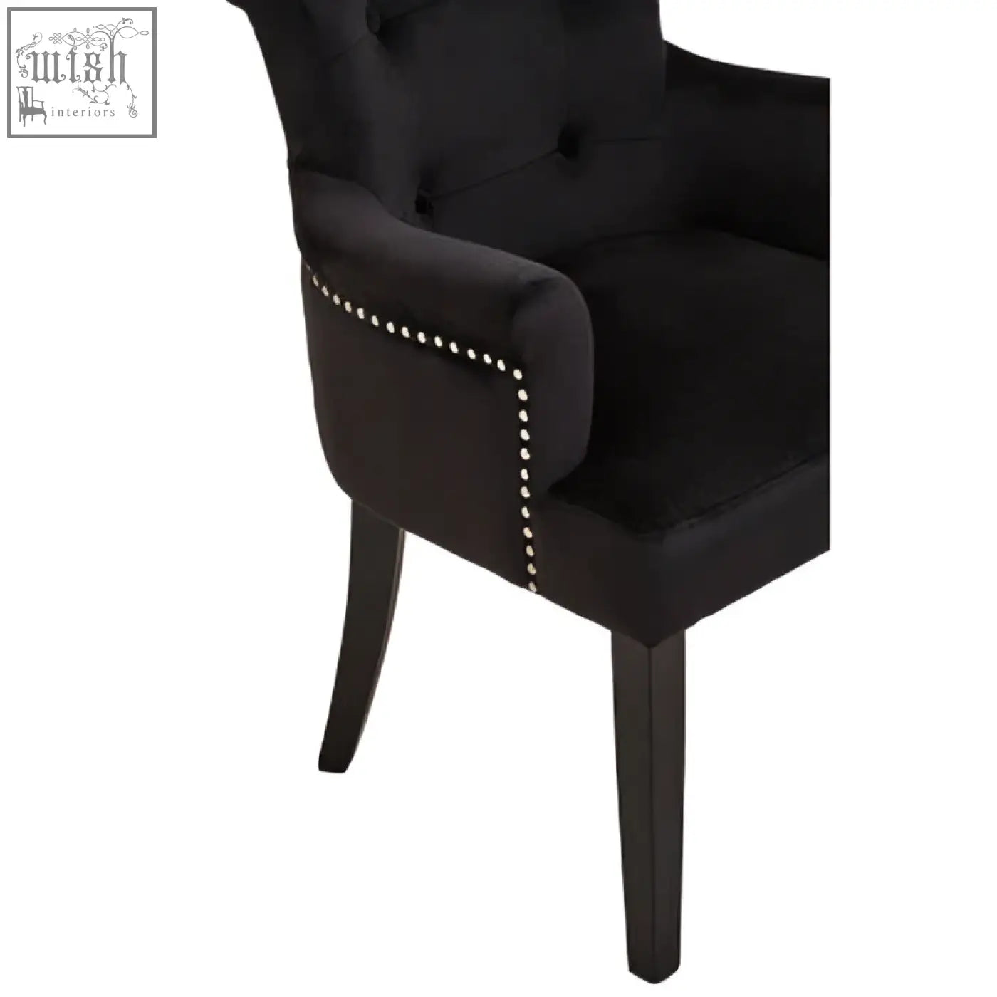 Black velvet dining chair with ring back and nailhead trim featuring a black tufted velvet armchair design
