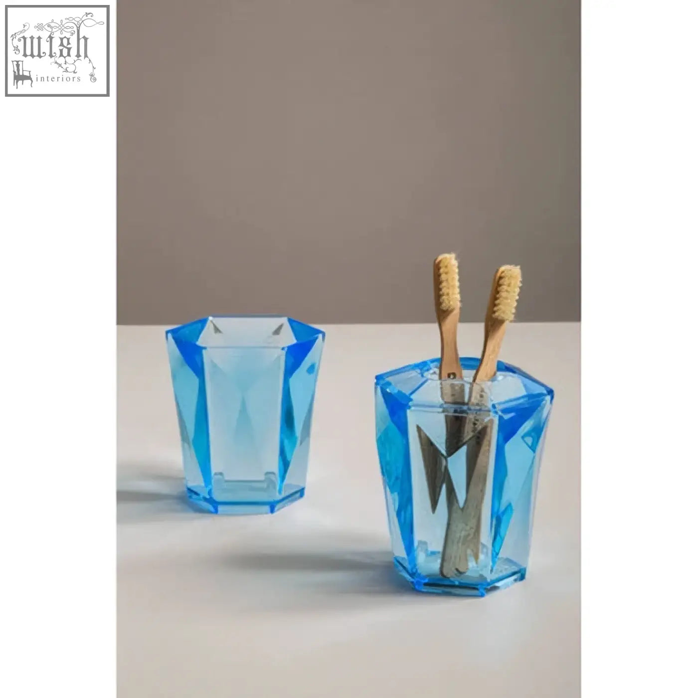Dow blue acrylic toothbrush holder with blue geometric faceted translucent acrylic design for bathroom use