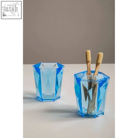 Blue acrylic tumbler toothbrush holder with dow blue acrylic faceted translucent design and tapered construction