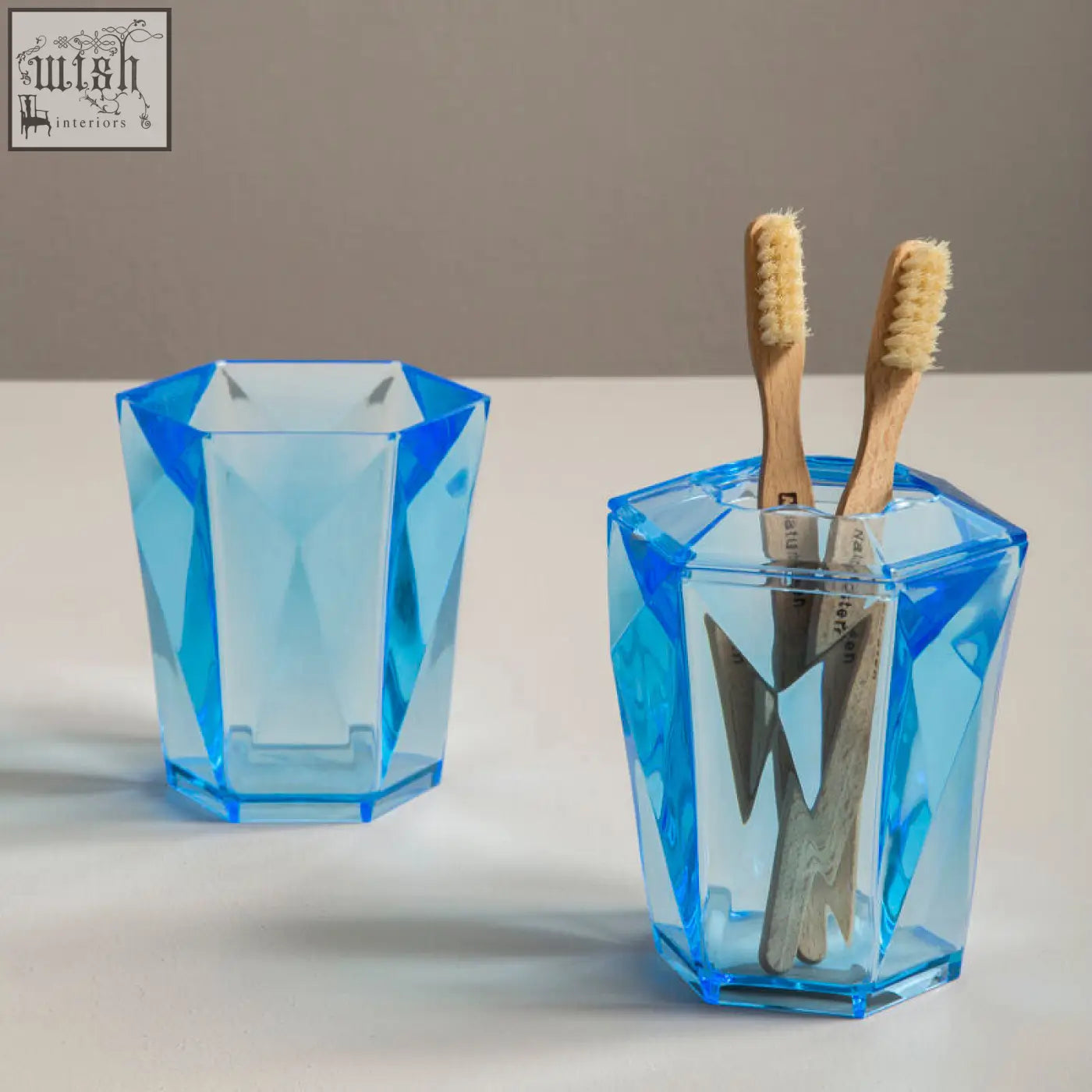 Dow blue acrylic tumbler in blue acrylic with tapered construction and faceted translucent geometric design
