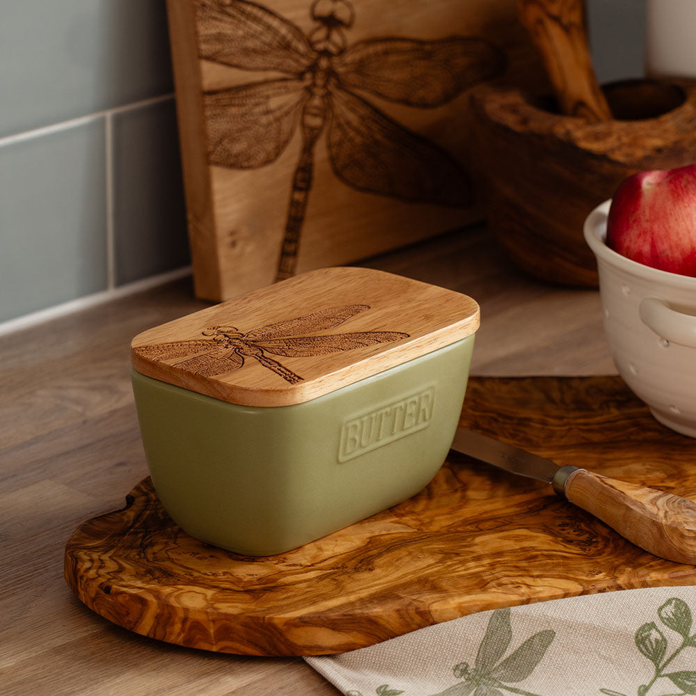 Olive green ceramic green butter dish with a natural wood lid and engraved dragonfly design in sage green tone
