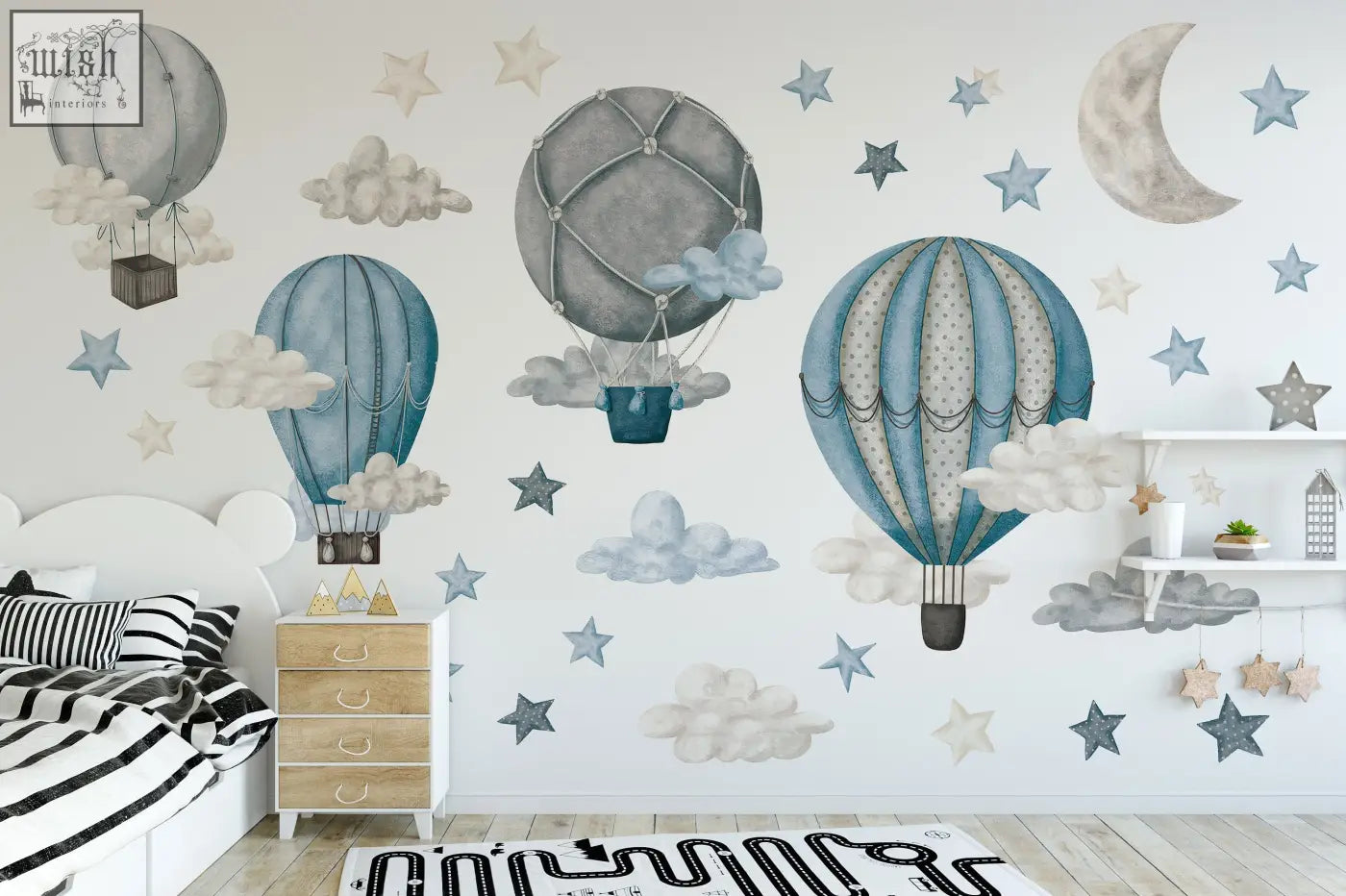 The dreamy hot air balloons and stars wall decals feature soft blue and gray whimsical nursery decor with clouds and stars
