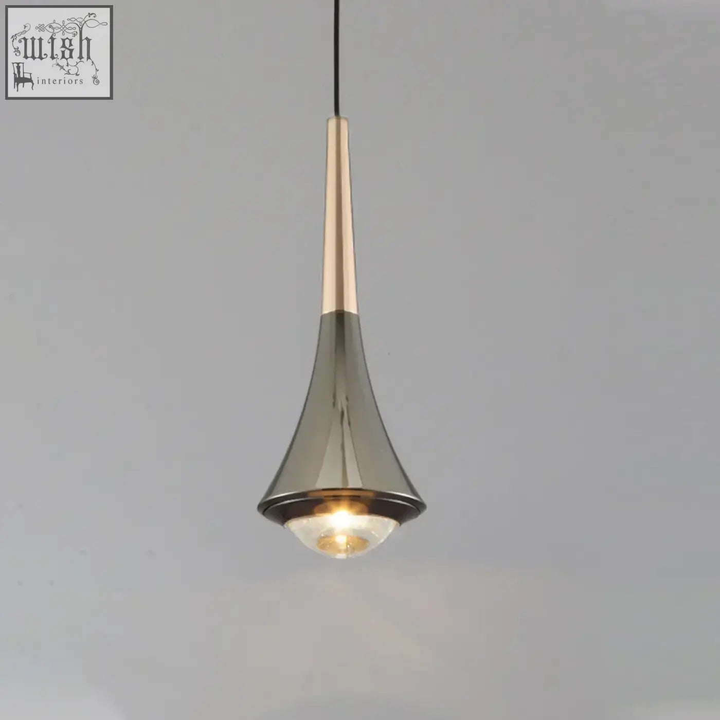 A sleek dropping pendant light with metallic gold and brushed silver finish and warm glowing led bulb