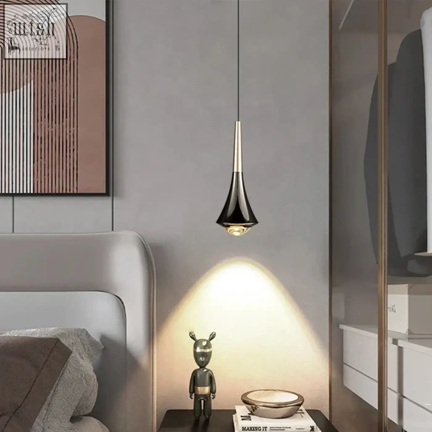 Black and gold dropping pendant light with sleek conical design and adjustable height hanging above bedside table