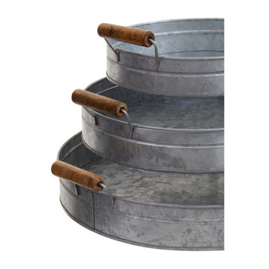 Stacked three round galvanised steel trays with wooden handles in the drummond set of three round trays