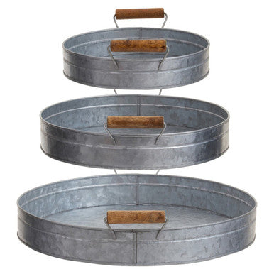 Stacked three round galvanised steel trays with wooden handles in the drummond set of three round galvanized trays