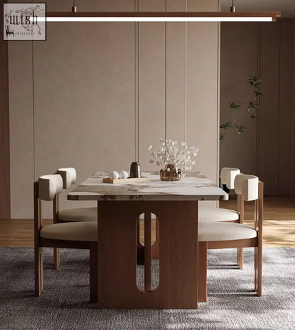 Modern dudley dining table with marble effect top and dark wood base with oval cutout surrounded by matching chairs