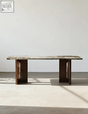 A sleek dudley dining table with a polished marble effect top and dark brown wooden legs with oval cutouts