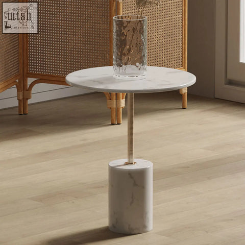 Dulcie side table marble featuring a white marble top with a cylindrical base and slender gold-toned central column