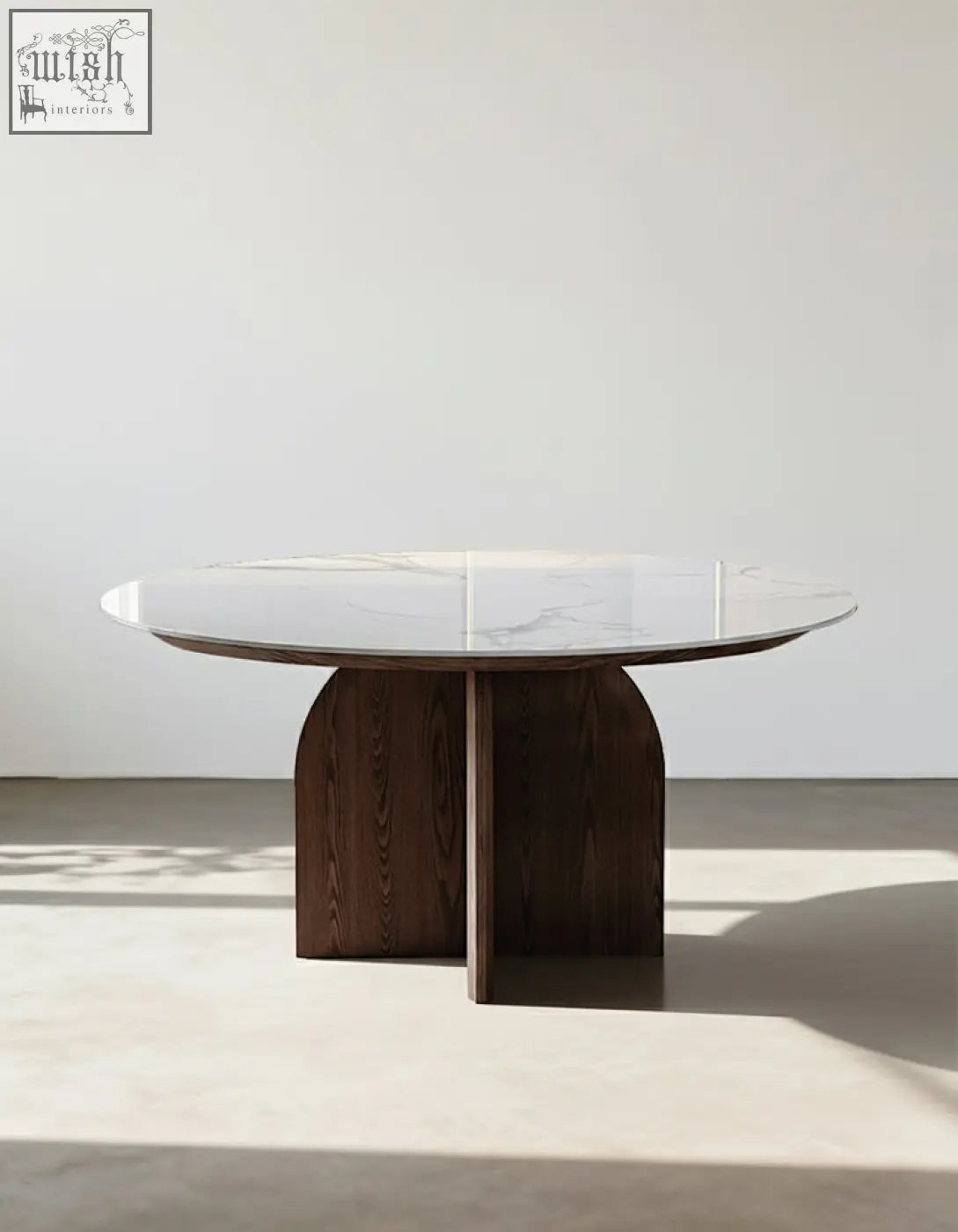 Modern round dunlap dining table with white sintered stone top and dark wood curved legs for stylish dining spaces