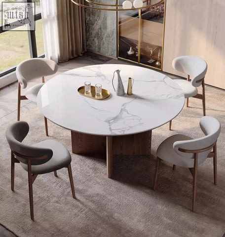 Round white marble dunlap dining table with central wooden base and four matching upholstered chairs in sintered stone