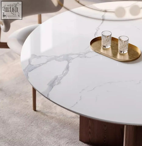 Dunlap dining table with a sleek oval white marble top and dark wood legs perfect for stylish dining spaces
