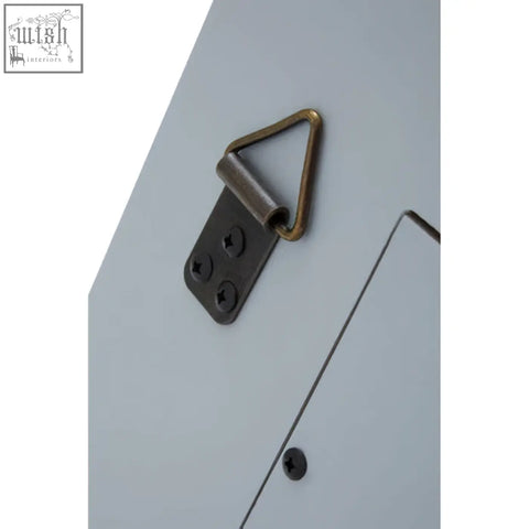 Back of duvali bevelled edge champagne silver wall mirror showing sleek matte black metal bracket with brass hook for hanging