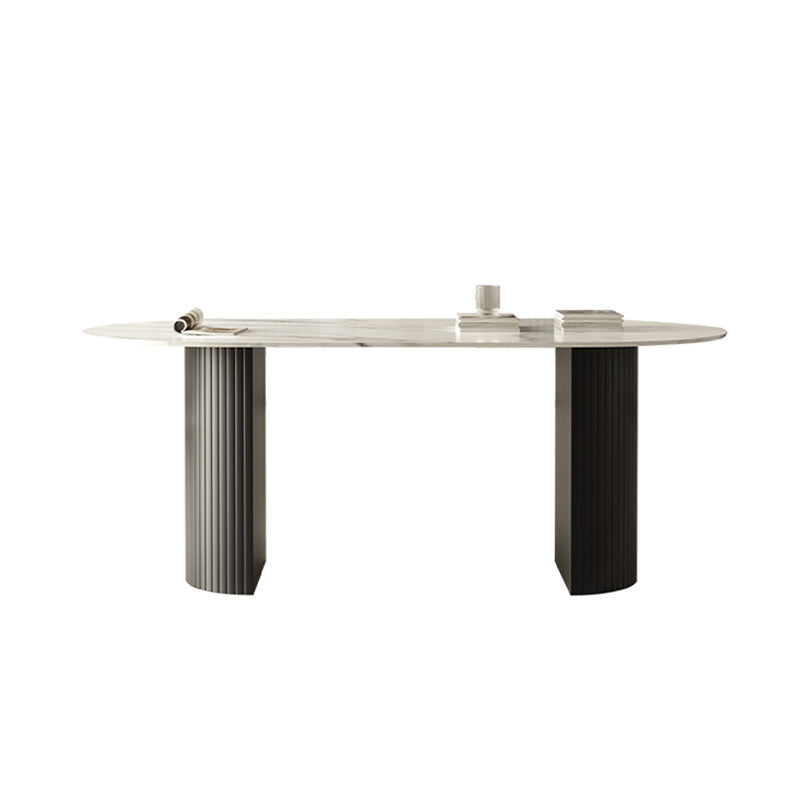 Modern oval dwight dining table with white marble top and contrasting silver and black fluted legs on minimalist supports