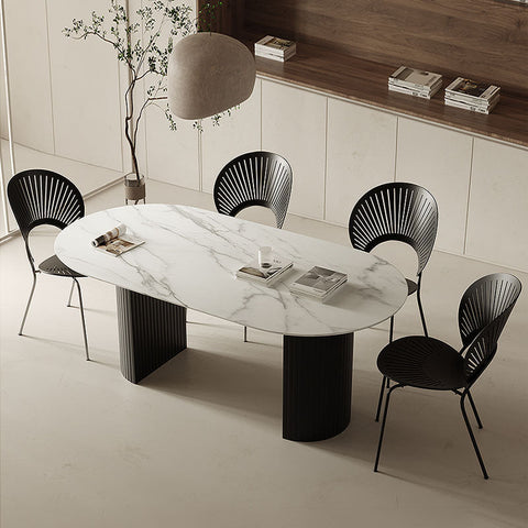 Modern dwight dining table with a white marble top and sleek black cylindrical legs perfect for stylish dining spaces
